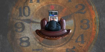 man in chair on desktop with clockface background