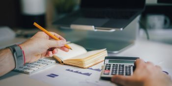 calculator and writing in notebook