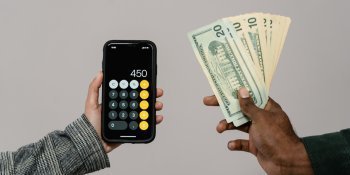 hands holding money and calculator